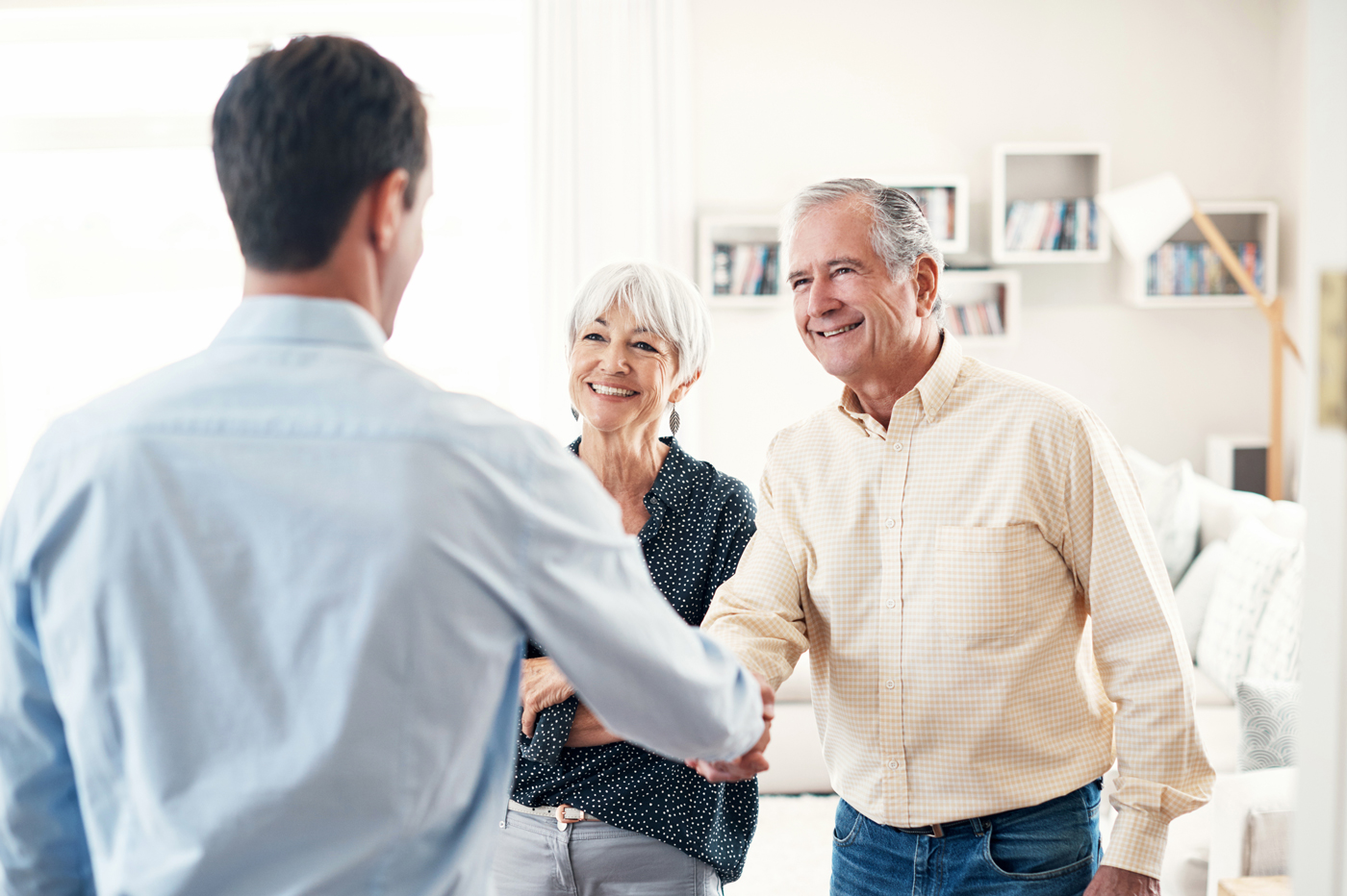 Shaking hands with older couple