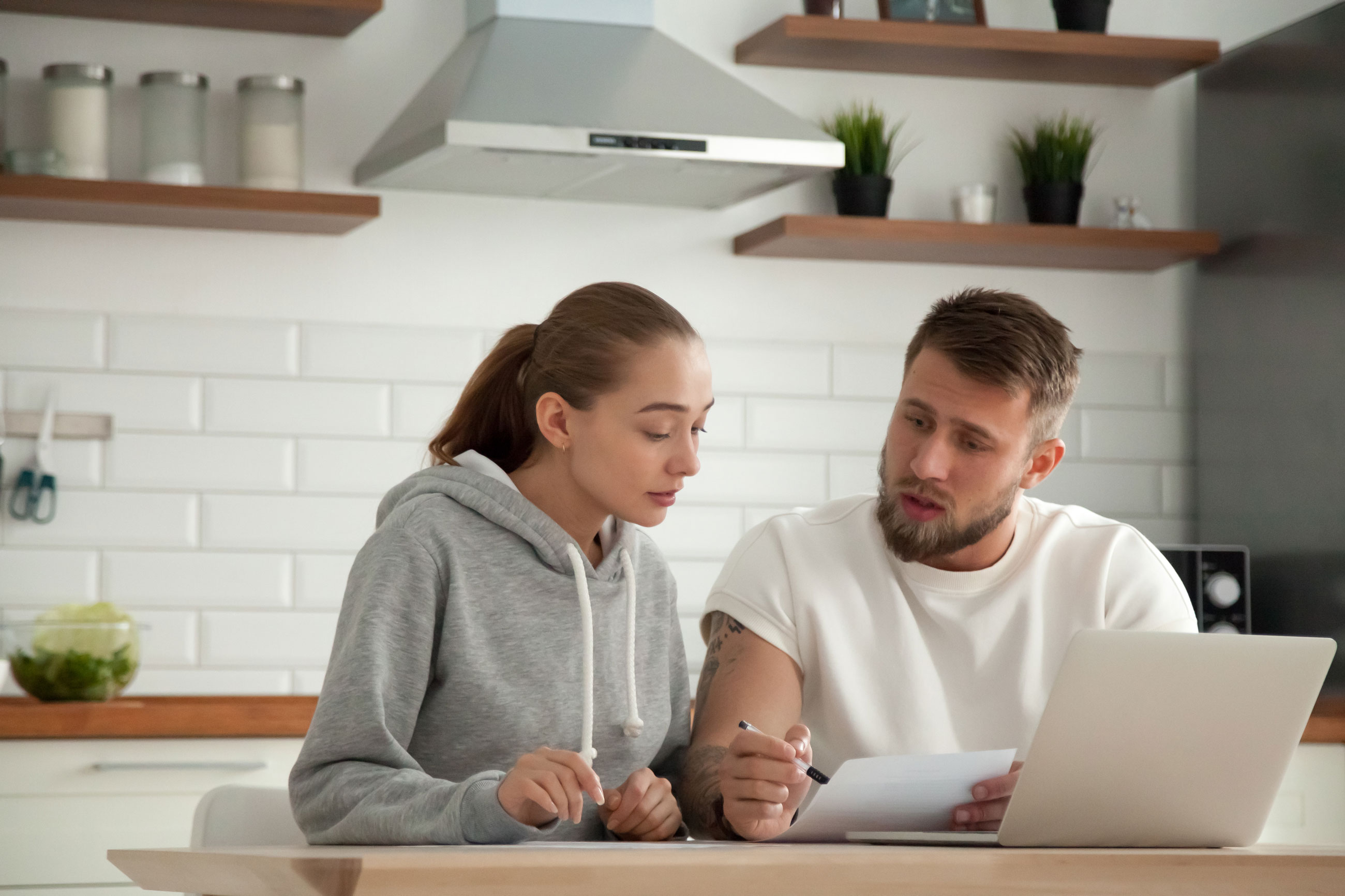 Young professional couple comparing bills